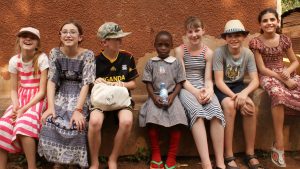 Highfield pupils with a Ugandan family outisde their home