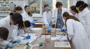 Sylvia Brett, Harrogate Ladies' College Principal, speaks with Lower 4 pupils taking part in the annual CSI Day as they carry out experiments at one of the school labs