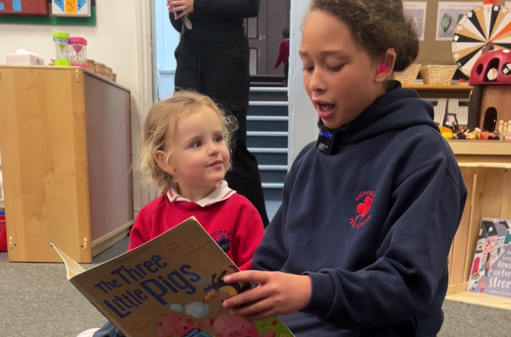 Highfield Prep 6 pupil reading to her reception buddy