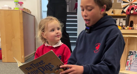 Highfield Prep 6 pupil reading to her reception buddy